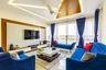 Contemporary Living Room with U-Shaped Blue Velvet Sofa Set, Off-White and Brown Coffee Table, and Floor-mounted TV Unit - Livspace