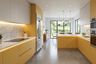 Modern Open Kitchen Design with Mustard Yellow and White Storage Cabinets
