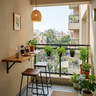 Small Balcony Design with Fold-Down Breakfast Counter and Tall Stools