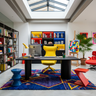 Colourful Workspace with Yellow Swivel Chair, Red Ottoman, Blue Stool and Palm