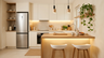 Open Kitchen Design with Champagne Coloured Cabinets and Wood Island
