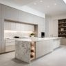 Steel and Champagne Modern Island Kitchen Design with Illuminated Island and Shelves