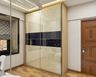 Glossy Wardrobe Design with Blue Panel - Livspace