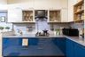 L-Shaped Blue And White Kitchen With Grey Countertop - Livspace