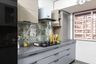 White and grey kitchen design with abstract tropical dado tiles - Livspace