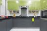 9x6 Ft Dark Grey and Green L-Shape Modular Kitchen with Granite Countertop - Livspace 9x6 Green Kitchen Design With Black And White Abstract Dado Tiles - Livspace 9x6 Green Kitchen Design With Tall Storage Unit And OTG - Livspace