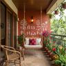 Balcony Design with Cane Swing and Red Warli Wall