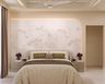 Curved Padded Bed in Guest Bedroom Design with Botanical Wall