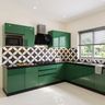L-Shaped Kitchen Design with Emerald Green Cabinets and Stainless Steel Sink