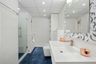Spacious White Bathroom Design- Livspace