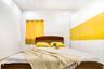 Guest Room With White And Mustard Wardrobe - Livspace