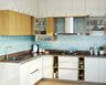 Ceramic Aqua Blue Triangular Tile Wall For Kitchen With White And Brown Kitchen Cabinets - Livspace