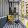 Modern Eclectic Balcony Design With Yellow Accent Chair, Moroccan Black And White Flooring, Grey And Wood Potted Plant-Storage Unit And 3D Leafy Wall Design - Livspace