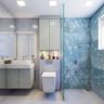 Dual-Toned White And Blue Bathroom Design With Grey Vanity Unit And Glass Partition - Livspace