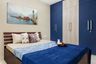 Spacious Guest Room Design With Wooden Bed And 6-Door Blue And Beige Swing Wardrobe - Livspace