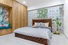 Spacious Guest Bedroom Design With Ornate Wooden Bed, 8-Door Swing Wooden Wardrobe And Multicoloured Wallpaper - Livspace