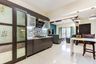 Slate grey kitchen design with grey and white backsplash and integrated mandir unit - Livspace