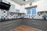 Grey And White L-Shape Kitchen Design With Patterend Backsplash  - Livspace