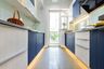 Light Wood And Blue Parallel Kitchen Design - Livspace