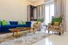 Colourful Living Room Design With Blue Sofa, Beige Patterned Accent Chairs And Integrated Mandir Unit - Livspace