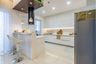 Modern Indian White Kitchen Cabinets With Breakfast Counter And Two High-Stools - Livspace