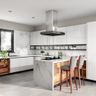 Spacious White Modular U-Shaped Kitchen Design With Marble Backsplash, Breakfast Counter And Wicker Baskets - Livspace