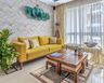 Colourful Living Room Design With Wooden Coffee Table, Yellow Sofa, Abstract Patterned Long Seater And Herringbone Wallpaper - Livspace