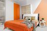 Spacious Master Bedroom Design With White And Black Queen-Size Bed, 3-Door Sliding Orange And White Sliding Wardrobe And Tri-Toned Wall - Livspace