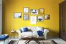 Bright Yellow Accent Wall Paint Design For Living Room With White Sofa - Livspace