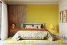 Bright Yellow Bedroom Wall Paint Design With Wooden Panel - Livspace