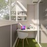 Compact Balcony With Space-Saving Furniture Including A White Study Table, Open Shelves And A Green Grass Flooring Mat - Livspace