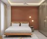 Compact Guest Bedroom Design With 4-Door Light Grey Swing Wardrobe With Glossy Finish, Light Brown Bed And Dark Brown Accent Wall With Wall Trims And Pendant Lights - Livspace