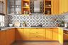 Yellow U-Shaped Kitchen Design With Black And White Star-Patterned Backsplash - Livspace
