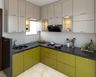Beige And Green L-Shape Modular Kitchen Design With White Kitchen Backsplash And Black Countertop - Livspace