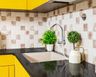 White Square Undermount Kitchen Sink With Black Countertop And Yellow Kitchen Cabinets - Livspace