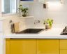 Top Mount Black Quartz Single Bowl Basin Wash With White Countertop And Yellow Cabinets - Livspace