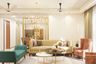 Living Room Design With Spacious Beige Sofa, Sea-Green Seater, Brown Accent Chairs, Dual-Toned Coffee Table And Gold Partition - Livspace