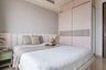 Guest Room Design With Light Pink And Wood Sliding Wardrobe - Livspace