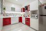 Red and white L shaped modular kitchen - Livspace