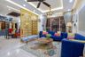 3-BHK Flat In Noida With Bright Blue L Shaped Living Room And Gold Partition - Livspace