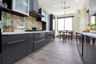Parallel glossy black kitchen design with Moroccan dado tiles - Livspace