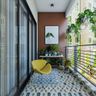 Modern Balcony Design with Brown Accent Wall, Painting, Multicoloured Abstract Flooring, Yellow Accent Chair, and White and Wood Table - Livspace